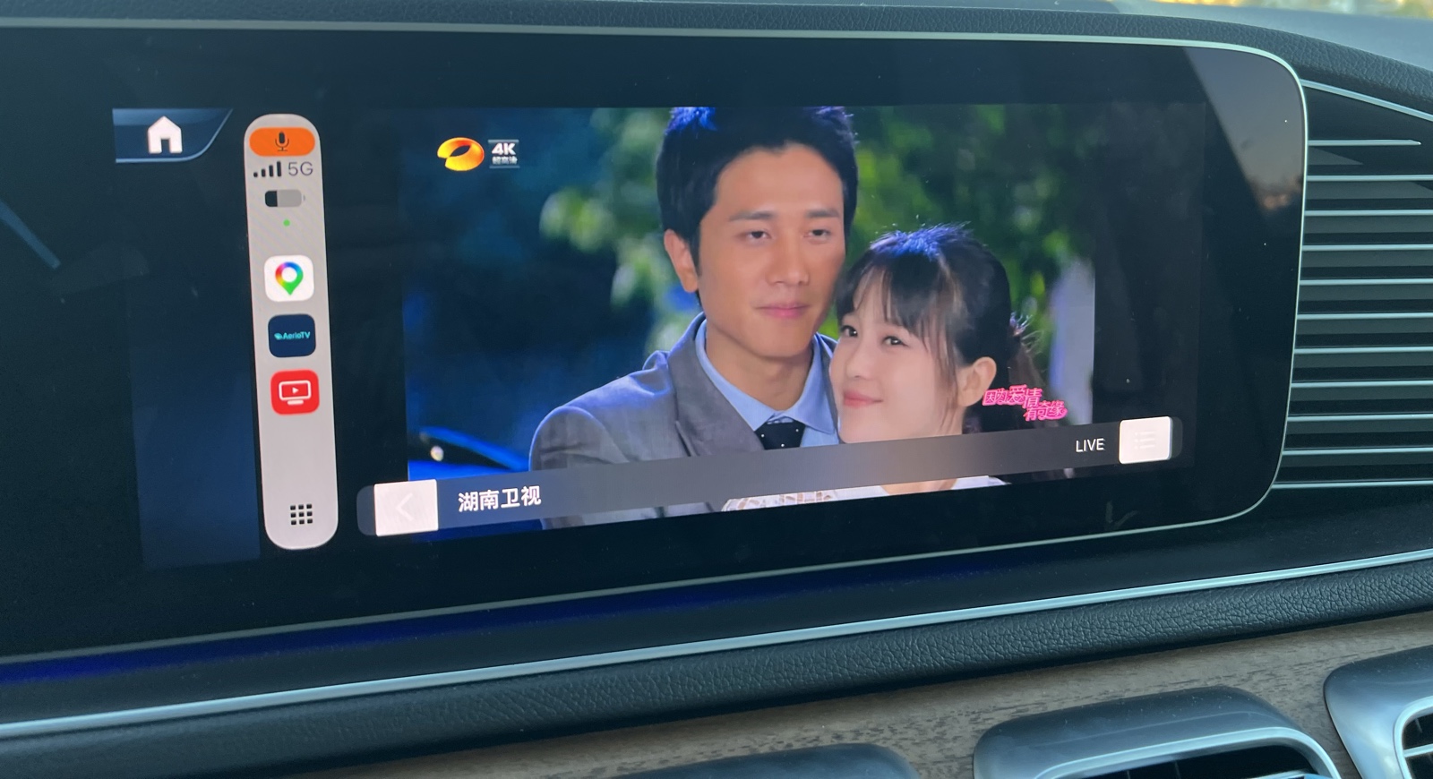 A live TV channel playing full screen on a car's CarPlay display